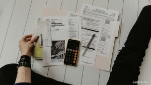 Desk with calculator and financial papers — salary guide