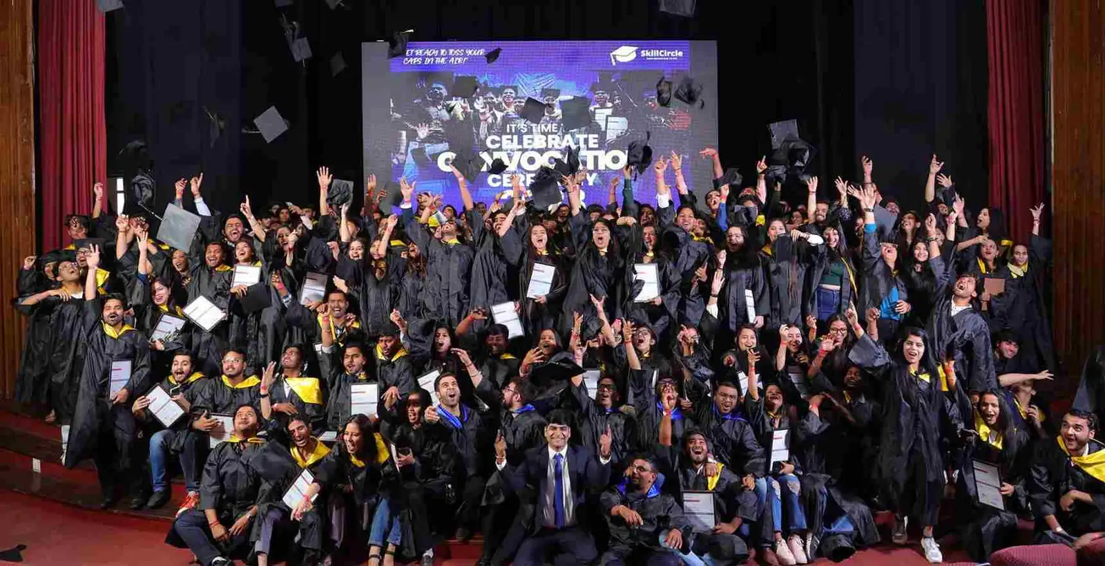 SkillCircle graduates in caps and gowns tossing their caps at the Convocation 2023 ceremony